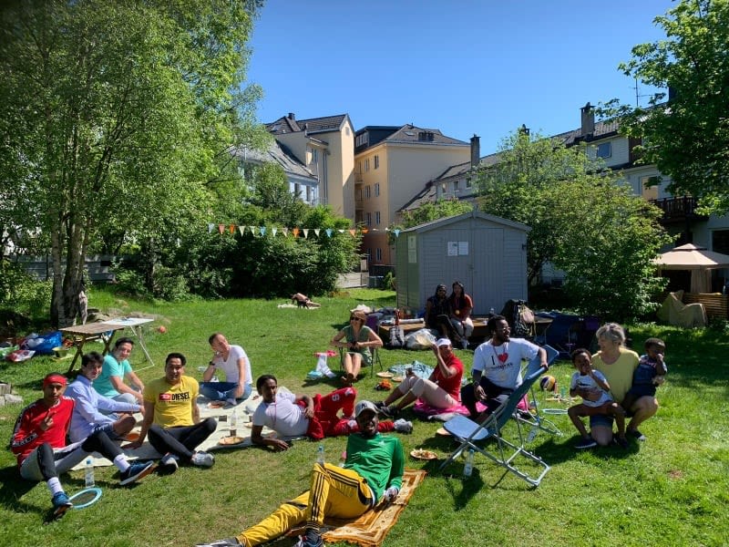 A group photo of people sitting in the park together